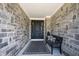 Inviting entryway features stone walls, a stylish front door, bench, and tasteful decor at 12725 Parsons Gate, Carmel, IN 46032