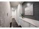 Well-lit hallway features stylish wallpaper, sleek built-in storage, and elegant trim detailing at 12725 Parsons Gate, Carmel, IN 46032