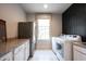 Well-equipped laundry room featuring a washer, dryer, and granite countertops for folding and sorting at 12725 Parsons Gate, Carmel, IN 46032