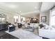 Expansive living room showcasing elegant decor, plush seating, and seamless flow to the kitchen and dining at 12725 Parsons Gate, Carmel, IN 46032