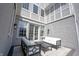 A gray brick patio with white cushions and coffee table at 12725 Parsons Gate, Carmel, IN 46032