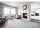 Comfortable sitting room with a fireplace, plush seating, and natural light at 12725 Parsons Gate, Carmel, IN 46032