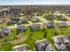 Aerial photo of a residential neighborhood with green spaces, mature trees, and pond at 16016 Viking Lair Rd, Westfield, IN 46074