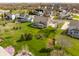 Aerial view of a home in a well-maintained neighborhood, featuring a large backyard and mature trees at 16016 Viking Lair Rd, Westfield, IN 46074