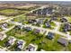 High-angle aerial view capturing a community's layout with pond, residential streets and green spaces at 16016 Viking Lair Rd, Westfield, IN 46074