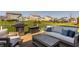 Backyard deck with grill and comfortable seating overlooking green backyard with other homes at 16016 Viking Lair Rd, Westfield, IN 46074