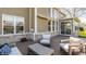 Backyard deck with comfortable seating and awning-covered porch with stone accents at 16016 Viking Lair Rd, Westfield, IN 46074