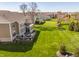 Spacious backyard featuring a deck with outdoor seating and a playset, surrounded by green grass at 16016 Viking Lair Rd, Westfield, IN 46074