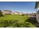 Large, green backyard with a deck and neighboring houses in a suburban neighborhood at 16016 Viking Lair Rd, Westfield, IN 46074