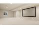 Finished basement with a home theater setup, projector screen, and ample space at 16016 Viking Lair Rd, Westfield, IN 46074