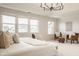 Bright bedroom featuring large windows offering backyard views and a sitting area with wicker chairs at 16016 Viking Lair Rd, Westfield, IN 46074