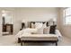 Bright, airy bedroom with a cozy bench at the foot of the bed and doorway to the Primary bath at 16016 Viking Lair Rd, Westfield, IN 46074