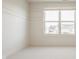 Bedroom with bright white walls and carpet, and a large window for natural light at 16016 Viking Lair Rd, Westfield, IN 46074