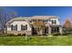 Beautiful two-story home with stone accents and manicured lawn on a clear day at 16016 Viking Lair Rd, Westfield, IN 46074