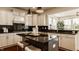 Modern kitchen with an island, stainless appliances, and white cabinetry at 16016 Viking Lair Rd, Westfield, IN 46074