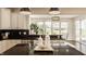 Kitchen with stainless steel appliances, black countertops and view to eating area at 16016 Viking Lair Rd, Westfield, IN 46074