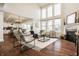 Spacious living room with fireplace, large windows, hardwood floors, and modern decor at 16016 Viking Lair Rd, Westfield, IN 46074