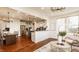 Spacious living room flows into kitchen and dining area, featuring hardwood floors at 16016 Viking Lair Rd, Westfield, IN 46074