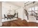 Bright living room and dining area with hardwood floors and staircase to the second floor at 16016 Viking Lair Rd, Westfield, IN 46074