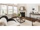Bright living room with fireplace, hardwood floors, and large windows at 16016 Viking Lair Rd, Westfield, IN 46074