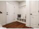 Traditional mudroom features coat rack and bench with cubbies, wood floors, and white trim at 16016 Viking Lair Rd, Westfield, IN 46074