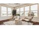 Bright sunroom featuring large windows, wicker furniture, and hardwood floors at 16016 Viking Lair Rd, Westfield, IN 46074