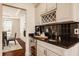 Elegant wet bar with wine storage, granite countertops, and a sleek design at 16016 Viking Lair Rd, Westfield, IN 46074