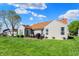 Spacious backyard with lush green grass, mature trees, and a cozy deck area at 1649 Woodfield Dr, Greenwood, IN 46143