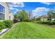 Beautifully landscaped backyard with a well-manicured lawn and mature trees, perfect for outdoor activities at 1649 Woodfield Dr, Greenwood, IN 46143