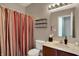 Bathroom showcasing a vanity with a sink, toilet, shelving and a shower with curtain at 1649 Woodfield Dr, Greenwood, IN 46143