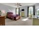 Spacious primary bedroom featuring plush carpeting, ceiling fan, and dresser at 1649 Woodfield Dr, Greenwood, IN 46143