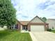 Charming single-story home with brick and siding exterior, well-manicured lawn, and two car garage at 1649 Woodfield Dr, Greenwood, IN 46143