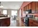 Eat-in kitchen featuring wood cabinets, granite countertops, and stainless steel appliances at 1649 Woodfield Dr, Greenwood, IN 46143