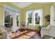 Bright sunroom with wicker furniture, large windows, and access to the deck at 1649 Woodfield Dr, Greenwood, IN 46143