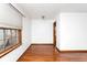 Hardwood floors are shown in a neutral-walled bedroom with window at 1726 N Euclid Ave, Indianapolis, IN 46218