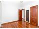 View of bedroom with hardwood floors, neutral walls, and wooden doors at 1726 N Euclid Ave, Indianapolis, IN 46218