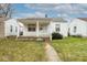 Charming single-story home with a covered front porch and well-maintained lawn at 1726 N Euclid Ave, Indianapolis, IN 46218