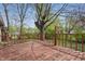 Back deck with wood railings and treed backyard. Deck has wood plank flooring at 1819 S Drexel Ave, Indianapolis, IN 46203