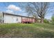 Back exterior view of home with wood deck and well-manicured lawn at 1819 S Drexel Ave, Indianapolis, IN 46203
