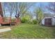 Expansive backyard featuring a small wooden deck and a storage shed at 1819 S Drexel Ave, Indianapolis, IN 46203
