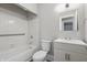Clean, well-lit bathroom with a shower-tub combination, vanity, and modern fixtures at 1819 S Drexel Ave, Indianapolis, IN 46203