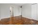 Bright bedroom featuring hardwood floors, neutral paint and seamless flow to the living room creating comfort and style at 1819 S Drexel Ave, Indianapolis, IN 46203