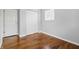 Bedroom with closet and doors showcases hardwood flooring and neutral paint at 1819 S Drexel Ave, Indianapolis, IN 46203