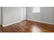 Bright bedroom featuring hardwood floors, neutral paint, spacious closet and natural light through the window at 1819 S Drexel Ave, Indianapolis, IN 46203