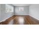 Cozy bedroom featuring hardwood floors, neutral paint and natural light through the window overlooking the yard at 1819 S Drexel Ave, Indianapolis, IN 46203