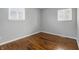 Cozy bedroom with hardwood flooring and natural light from the double windows at 1819 S Drexel Ave, Indianapolis, IN 46203