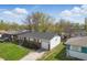 Aerial view of brick and siding single-Gathering home with a driveway and landscaping at 1819 S Drexel Ave, Indianapolis, IN 46203