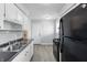 Efficient kitchen with black appliances, bright white cabinets, modern countertops and convenient access to the rest of home at 1819 S Drexel Ave, Indianapolis, IN 46203