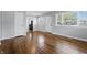 Bright living room showcasing hardwood floors, neutral paint and open layout with natural light from multiple windows at 1819 S Drexel Ave, Indianapolis, IN 46203