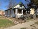 Exterior view of a house with boarded up windows, and a wooden ramp leading to the porch at 1924 E Maryland St, Indianapolis, IN 46201